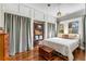 Bright bedroom featuring hardwood floors, built-in shelving, and a comfortable bed with decorative pillows at 333 Drexel Ave, Decatur, GA 30030