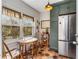 Breakfast nook with green cabinets and stainless refrigerator, flooded with natural light through large windows at 333 Drexel Ave, Decatur, GA 30030