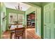 Inviting dining room featuring green walls, a wooden table, and views to the living room at 333 Drexel Ave, Decatur, GA 30030