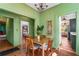 Charming dining room featuring light green walls, wood floors, and a view into the kitchen at 333 Drexel Ave, Decatur, GA 30030