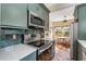 Cozy kitchen with green cabinetry, stainless appliances, and breakfast nook with large windows at 333 Drexel Ave, Decatur, GA 30030