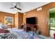 Comfortable living room with ceiling fan, patterned sofa, and a work desk with a large television at 333 Drexel Ave, Decatur, GA 30030