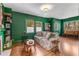 Stylish living room featuring green walls, hardwood floors, and tapestry wall decor at 333 Drexel Ave, Decatur, GA 30030