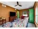 Cozy living room with a ceiling fan, desk, vintage sofa, and a bright green wardrobe at 333 Drexel Ave, Decatur, GA 30030
