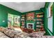 Comfortable living room featuring a decorative fireplace, built-in bookshelves, and hardwood floors at 333 Drexel Ave, Decatur, GA 30030