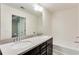 Bright bathroom featuring double sinks with dark cabinets and a large mirror at 992 Belfry Ter, Fairburn, GA 30213