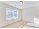 Sunlit bedroom with a large window and neutral carpet at 992 Belfry Ter, Fairburn, GA 30213