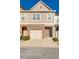 Charming townhome with brick accents, an attached garage, and inviting curb appeal at 992 Belfry Ter, Fairburn, GA 30213