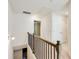 Upstairs hallway with wood and metal railing that overlooks the staircase at 992 Belfry Ter, Fairburn, GA 30213