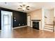 Living room with hardwood floors, an electric fireplace, and views of the staircase and doorway at 992 Belfry Ter, Fairburn, GA 30213
