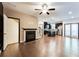 Open-concept living room featuring a fireplace, hardwood floors, and a seamless flow to the kitchen at 992 Belfry Ter, Fairburn, GA 30213