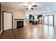 Spacious open living area with hardwood floors, fireplace, and natural light flowing into the kitchen at 992 Belfry Ter, Fairburn, GA 30213