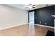 Open living area with hardwood floors, a dark accent wall, and recessed lighting at 992 Belfry Ter, Fairburn, GA 30213