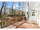 A wood deck on the back of the house with wooden railings provides an inviting outdoor space at 130 Cauley Club Ct, Johns Creek, GA 30097