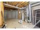 Unfinished basement with concrete walls, exposed pipes, and utility systems, ready for customization at 130 Cauley Club Ct, Johns Creek, GA 30097