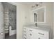 Updated bathroom with a sleek vanity, marble countertops, and a shower with glass doors at 130 Cauley Club Ct, Johns Creek, GA 30097