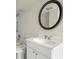 Well-lit bathroom featuring a vanity with a white sink, decorative mirror, and a shower-tub combination at 130 Cauley Club Ct, Johns Creek, GA 30097