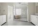 Elegant bathroom featuring double vanity, a soaking tub, and a spacious walk-in shower with glass door at 130 Cauley Club Ct, Johns Creek, GA 30097