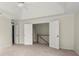 Bedroom with neutral walls, carpeted flooring, and double doors leading to a hallway at 130 Cauley Club Ct, Johns Creek, GA 30097