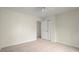 Bedroom with a ceiling fan, carpet, and double door closet at 130 Cauley Club Ct, Johns Creek, GA 30097