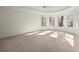 Bright bedroom featuring neutral walls, carpet, and several windows providing natural light at 130 Cauley Club Ct, Johns Creek, GA 30097