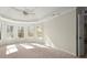 Bright bedroom featuring neutral walls, carpet, and windows providing natural light at 130 Cauley Club Ct, Johns Creek, GA 30097