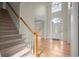 Bright and airy foyer with hardwood floors, a staircase, and a large front door at 130 Cauley Club Ct, Johns Creek, GA 30097