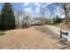 Large two-story home with a landscaped yard and a long, curved driveway at 130 Cauley Club Ct, Johns Creek, GA 30097
