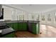 Modern kitchen with stainless steel appliances, green cabinets, and a breakfast nook with views at 130 Cauley Club Ct, Johns Creek, GA 30097