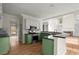 Well-lit kitchen features modern appliances, granite counters, and an open concept to living area at 130 Cauley Club Ct, Johns Creek, GA 30097
