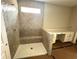 Luxurious bathroom featuring a tiled shower, bench, and a vanity area, designed for relaxation and convenience at 33 Cambridge Ln, Dallas, GA 30157