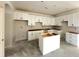 Spacious kitchen with white cabinets, drawers, and an island; ready to be topped with beautiful counter tops at 33 Cambridge Ln, Dallas, GA 30157