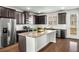 Modern kitchen featuring stainless steel appliances, granite countertops, and dark wood cabinets at 4358 White Spruce Aly, Doraville, GA 30360