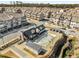 Aerial view of community pool, clubhouse and townhomes surrounded by lush greenery and well-kept streets at 4358 White Spruce Aly, Doraville, GA 30360