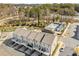 An aerial shot of modern townhomes with private balconies, garages, and a scenic pond nearby at 4358 White Spruce Aly, Doraville, GA 30360
