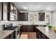 Well-equipped kitchen with dark wood cabinets and stainless steel appliances at 4358 White Spruce Aly, Doraville, GA 30360