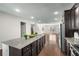 Open-concept living area adjoining the kitchen, with hardwood floors and recessed lighting at 4358 White Spruce Aly, Doraville, GA 30360