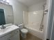 Bright bathroom featuring a shower-tub combo, vanity, and tile flooring at 585 Mcwilliams Se Rd # 2602, Atlanta, GA 30315