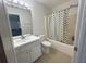 Bathroom features a white vanity, mirror, tile flooring, and a shower with a patterned curtain at 585 Mcwilliams Se Rd # 2602, Atlanta, GA 30315