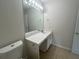 Well-lit bathroom featuring a long vanity, large mirror, and tile flooring at 585 Mcwilliams Se Rd # 2602, Atlanta, GA 30315