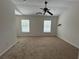 Carpeted bedroom featuring a ceiling fan, with two windows allowing for natural light at 585 Mcwilliams Se Rd # 2602, Atlanta, GA 30315