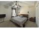 This bedroom features a ceiling fan, large bed, curtains and two wall lamps at 585 Mcwilliams Se Rd # 2602, Atlanta, GA 30315