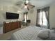 This bedroom features a television, a large bed and an area with a desk at 585 Mcwilliams Se Rd # 2602, Atlanta, GA 30315