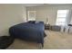 This bedroom features a bed, two windows with blinds and laundry baskets at 585 Mcwilliams Se Rd # 2602, Atlanta, GA 30315