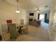 Open-concept living room features glass table and fireplace with access to the dining room and sitting area at 585 Mcwilliams Se Rd # 2602, Atlanta, GA 30315