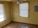 A bedroom shows a ceiling fan and two windows with blinds at 8090 Colquitt St, Douglasville, GA 30134