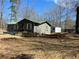 View of the back of the home and the partially wooded lot at 8090 Colquitt St, Douglasville, GA 30134