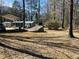 Single story home on a lot with mature trees and a covered parking area at 8090 Colquitt St, Douglasville, GA 30134