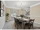 Staged dining room with a large window, dining table, and modern chandelier fixture at 1056 Shadow Lake Dr, Lithonia, GA 30058