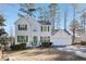 Charming two-story home with green shutters, a well-manicured lawn, and a two-car garage at 1056 Shadow Lake Dr, Lithonia, GA 30058